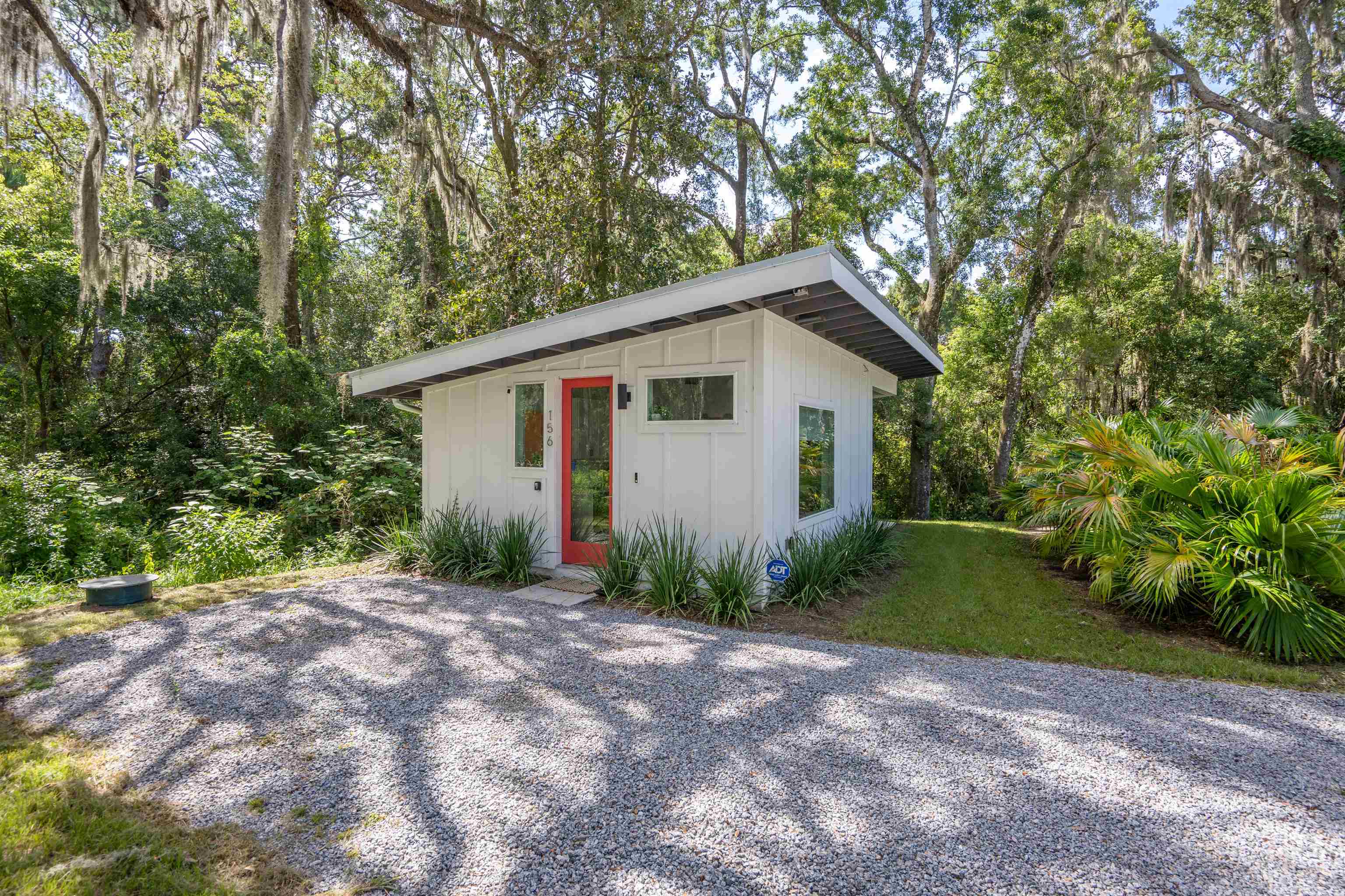 156 North St Johns Street St. Augustine, FL 32084 - Photo 2 of 14 a view of a backyard with plants and large trees