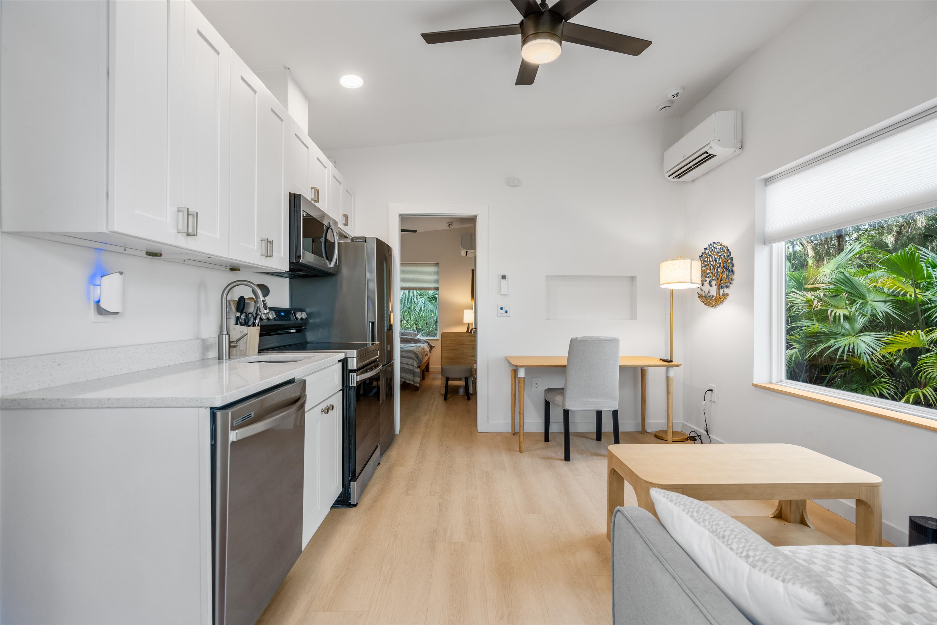 156 North St Johns Street St. Augustine, FL 32084 - Photo 6 of 14 a kitchen with a table chairs microwave and cabinets