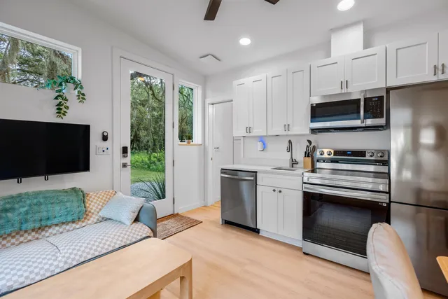 a kitchen with stainless steel appliances granite countertop a stove a sink and a refrigerator