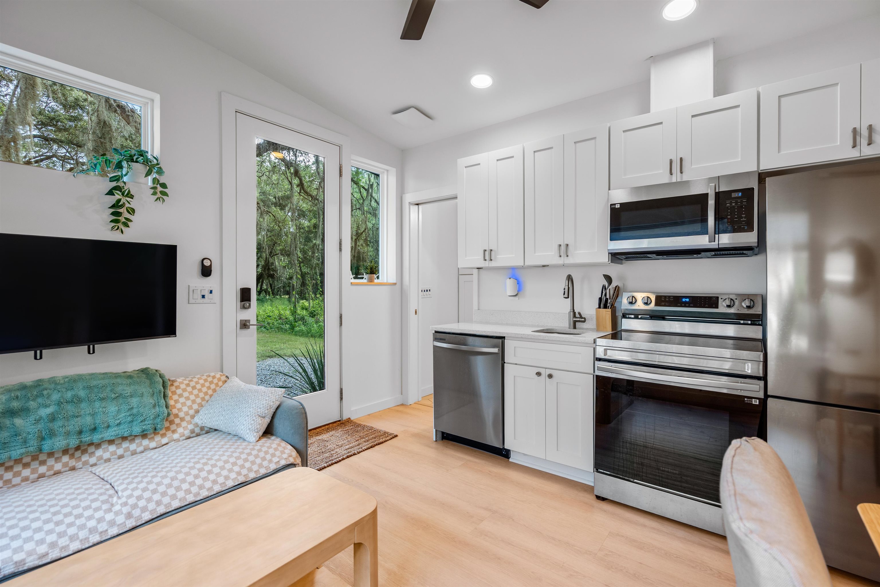 156 North St Johns Street St. Augustine, FL 32084 - Photo 9 of 14 a kitchen with stainless steel appliances granite countertop a stove a sink and a refrigerator