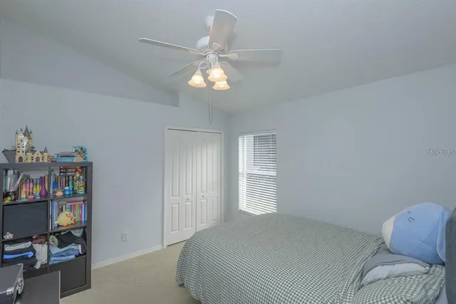 a bedroom with a bed and window