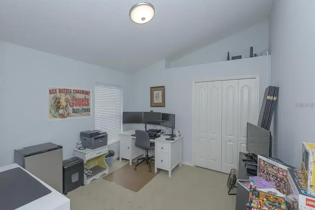 a view of a workspace with furniture and a window