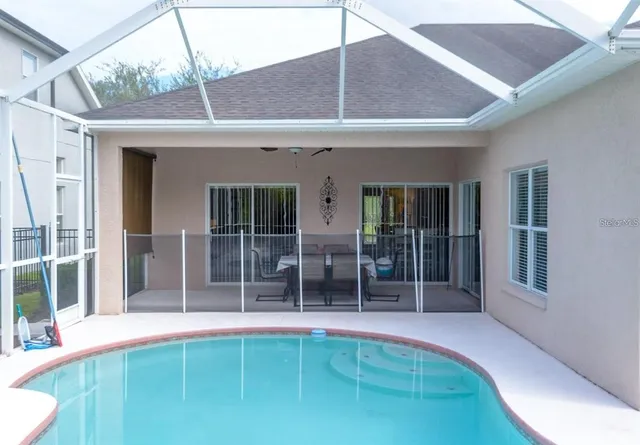 a view of swimming pool with outdoor seating