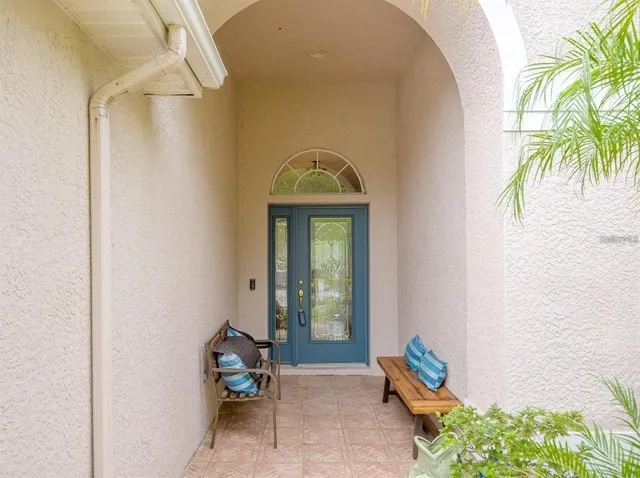 a living room with a couch and a potted plant