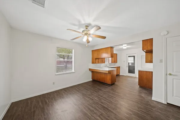 a living room with furniture and a wooden floor
