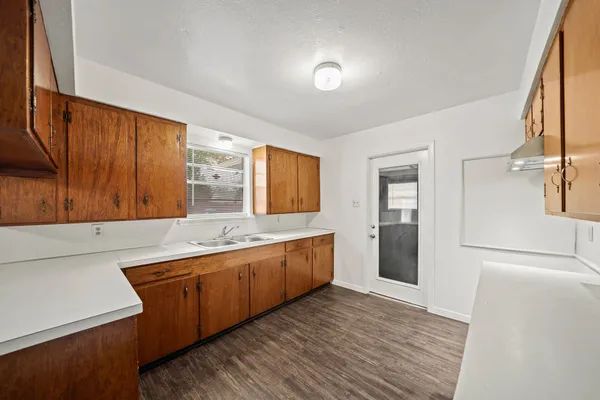 a large kitchen with stainless steel appliances granite countertop a sink and a stove top oven