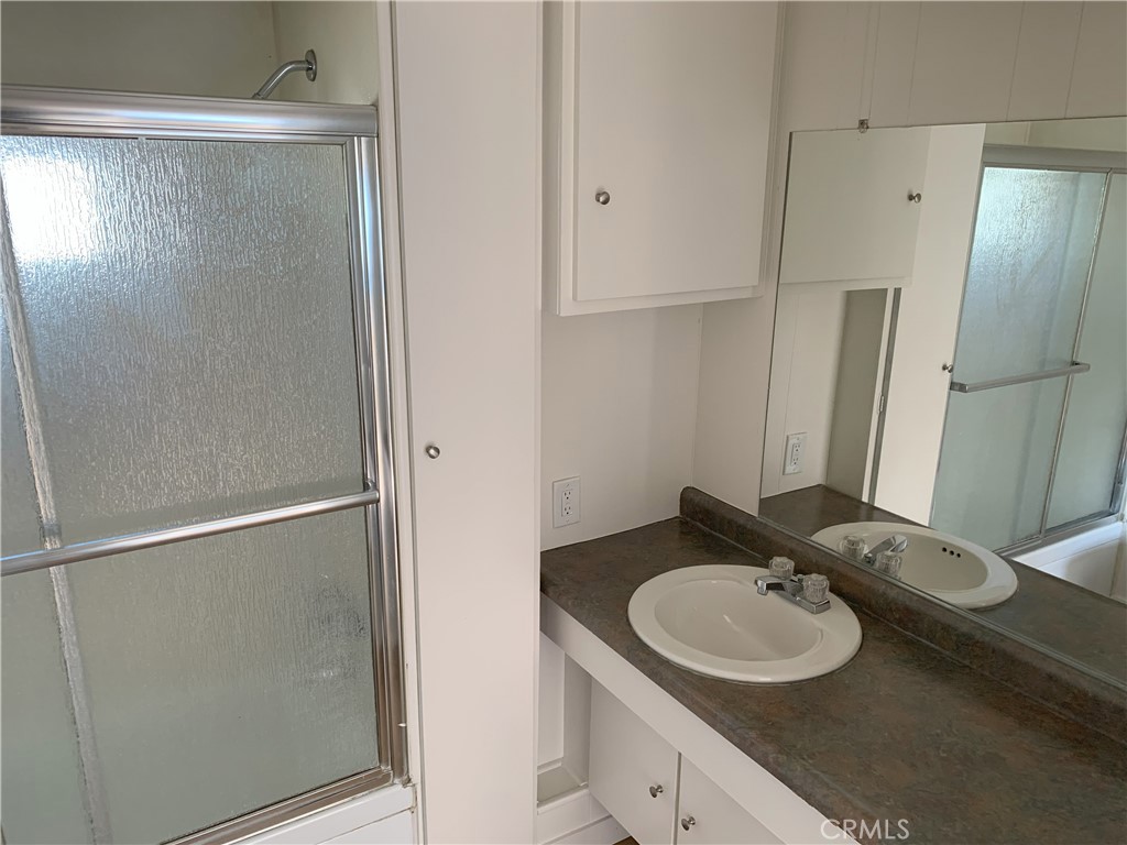 5925 Riverside Drive, Unit 12 Chino, CA 91710 - Photo 11 of 16 a bathroom with a sink and a mirror