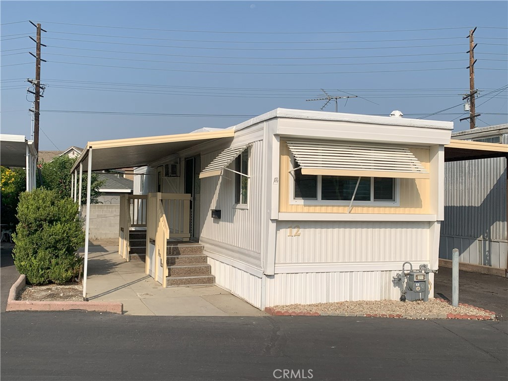 5925 Riverside Drive, Unit 12 Chino, CA 91710 - Photo 2 of 16 a front view of a house with a garage