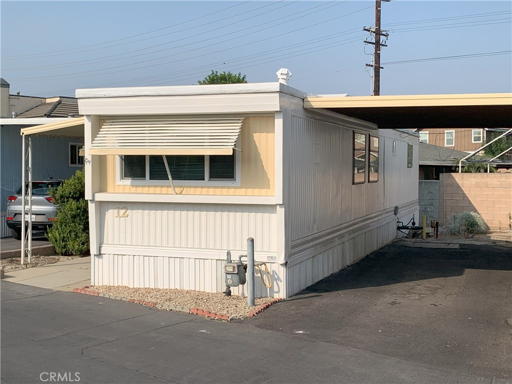 5925 Riverside Drive, Unit 12 Chino, CA 91710 - Photo 3 of 16 a view of a house with a garage