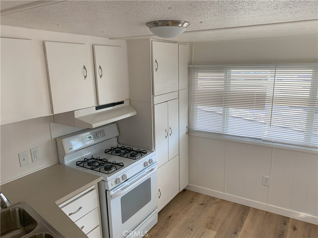 5925 Riverside Drive, Unit 12 Chino, CA 91710 - Photo 8 of 16 a kitchen with a stove and a refrigerator