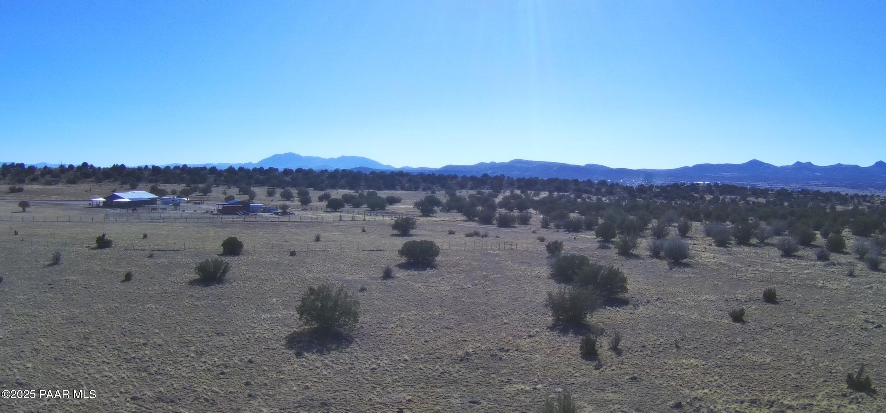 95 J North Headwaters Road Paulden, AZ 86334 - Photo 14 of 37 a view of a dry field with lots of trees in the background