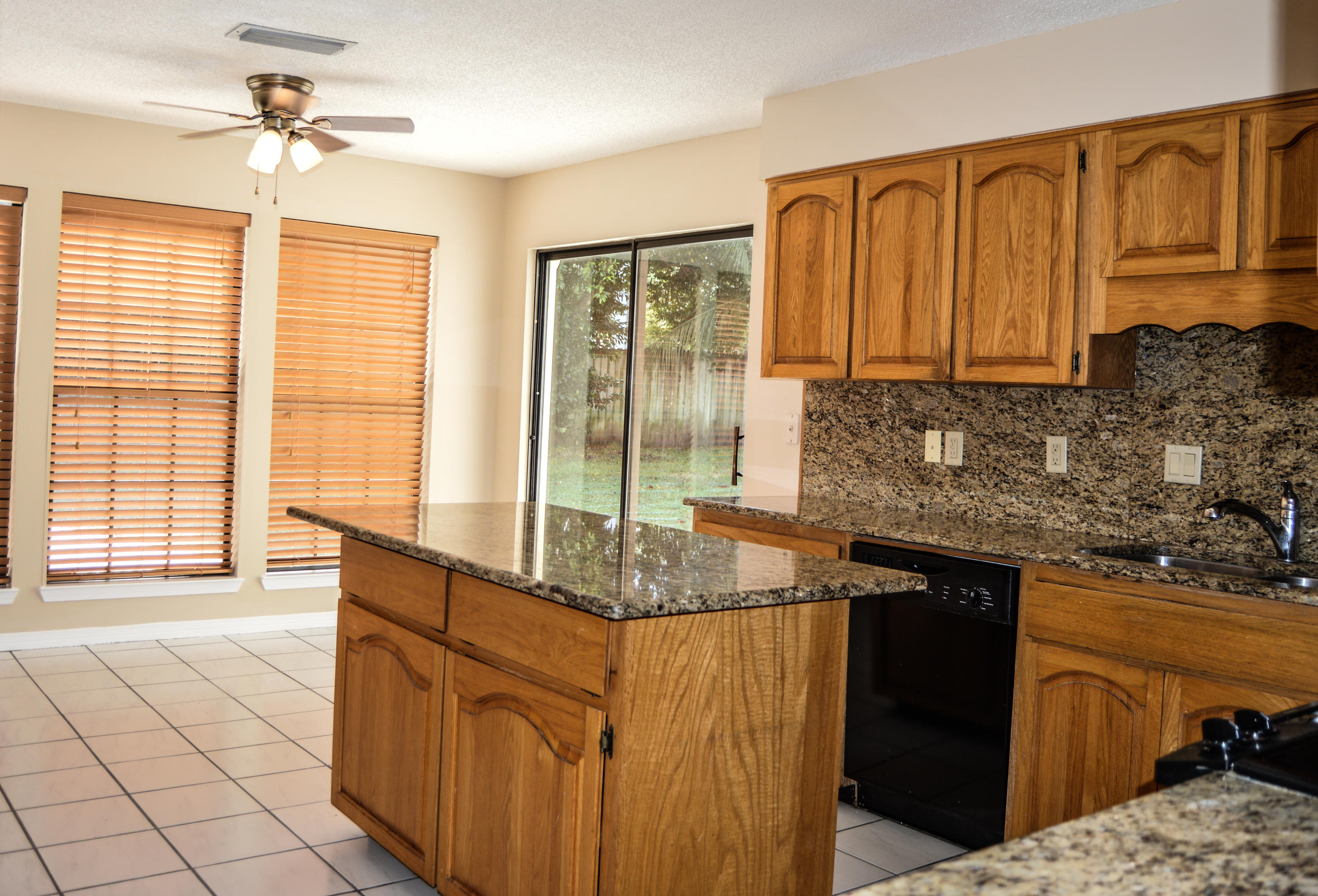 319 Ruckel Drive Niceville, FL 32578 - Photo 13 of 27 a kitchen with stainless steel appliances granite countertop a sink stove and cabinets