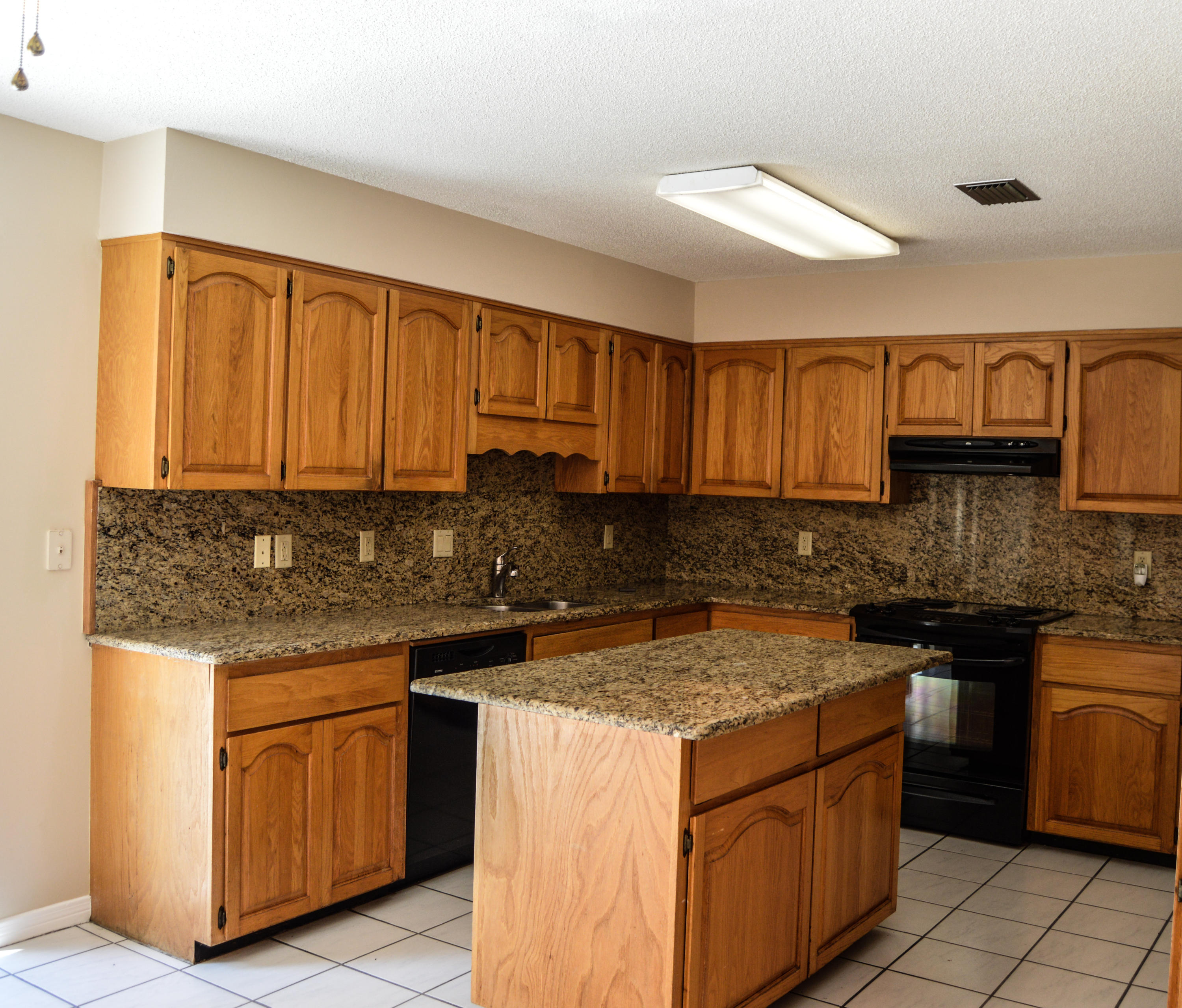 319 Ruckel Drive Niceville, FL 32578 - Photo 14 of 27 a kitchen with stainless steel appliances granite countertop a stove a sink and a microwave