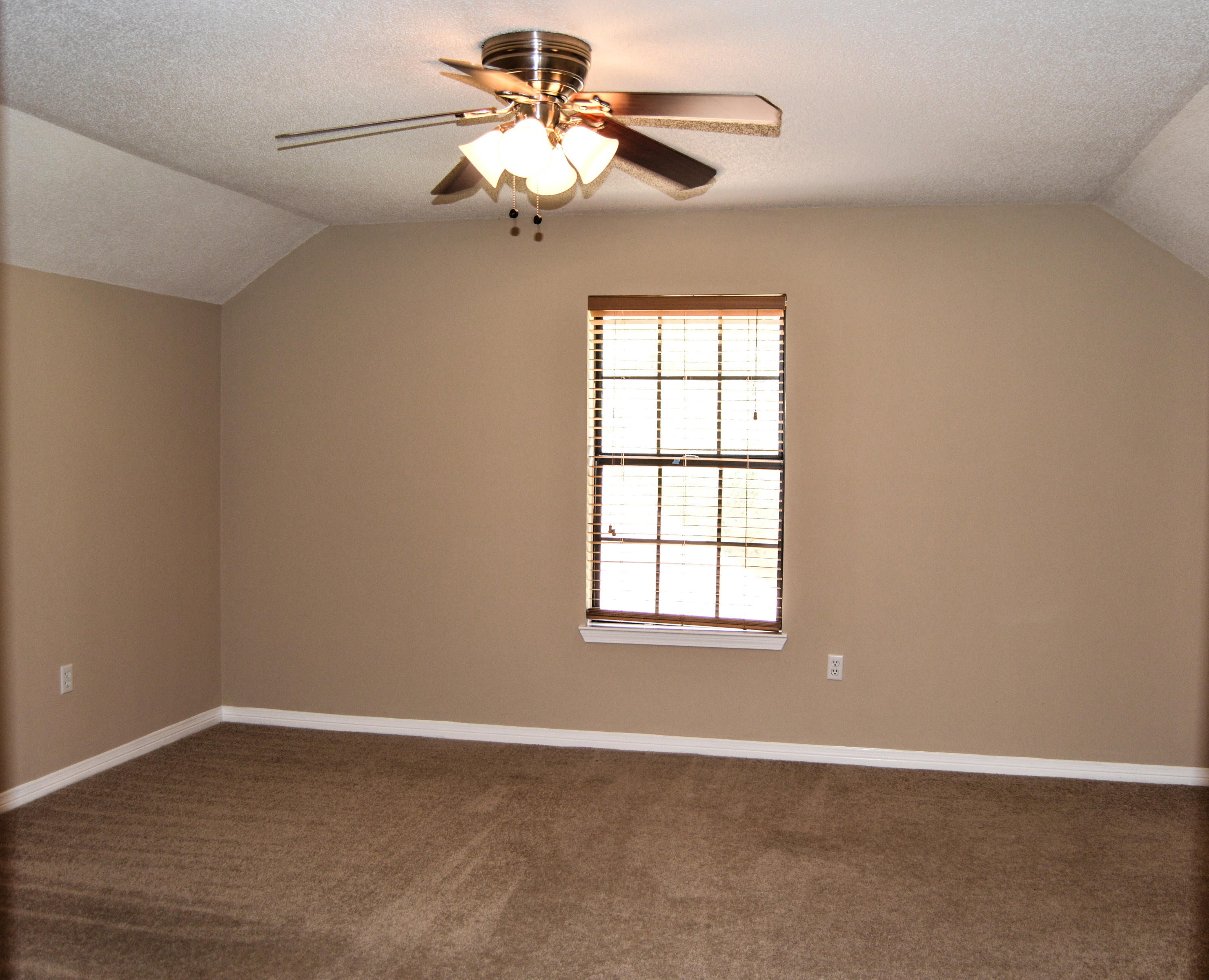 319 Ruckel Drive Niceville, FL 32578 - Photo 15 of 27 an empty room with a chandelier fan and windows