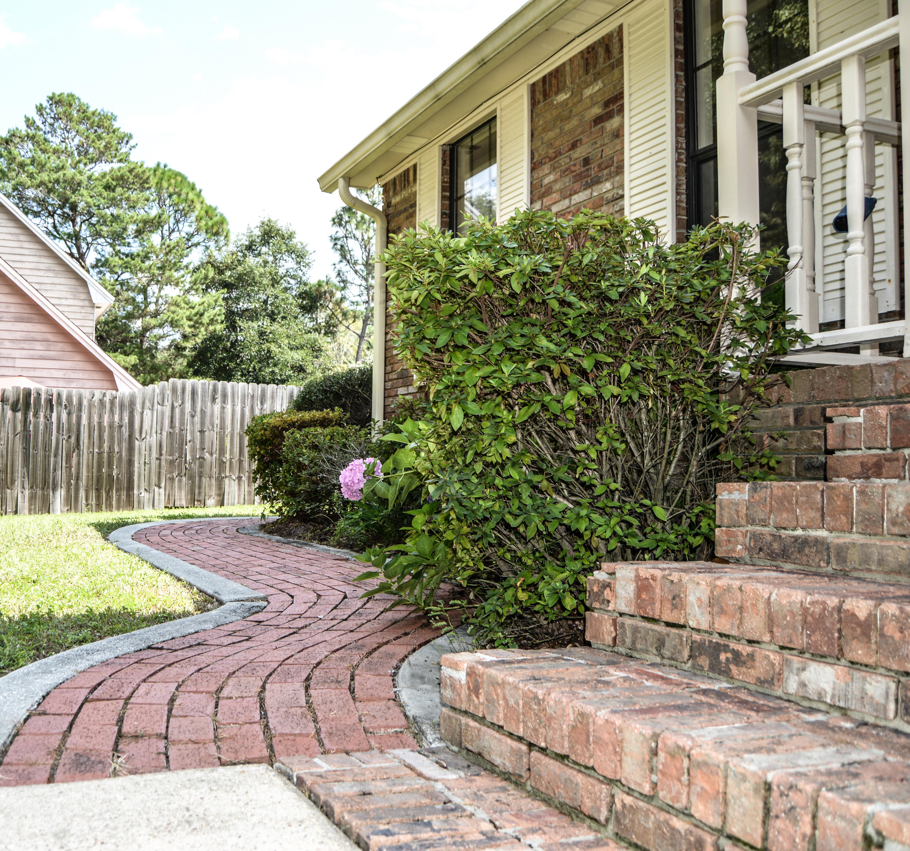 319 Ruckel Drive Niceville, FL 32578 - Photo 16 of 27 a view of a backyard with couches plants and wooden fence