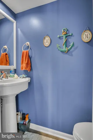 a bathroom with a sink mirror and toilet