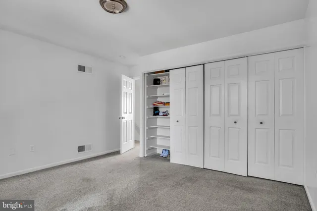 a view of an empty room and closet area