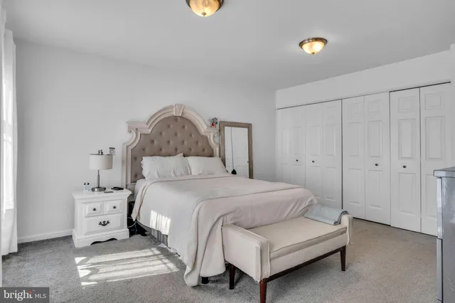 a bedroom with a bed and a lamp