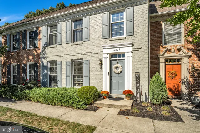 a view of a brick house with potted plants