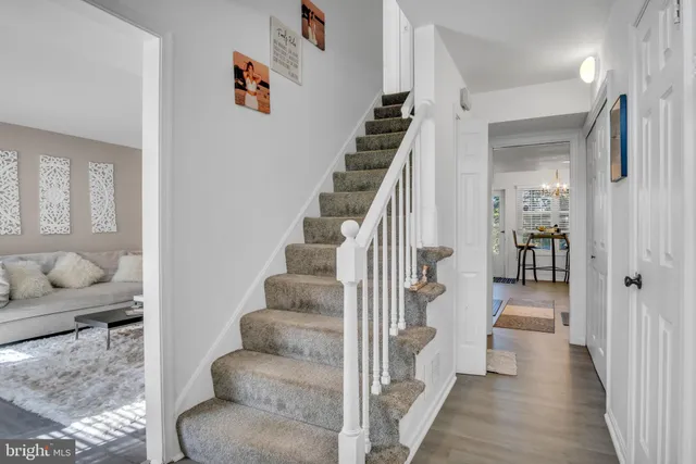 a view of entryway and hall with wooden floor
