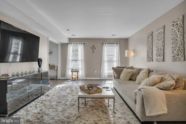 a living room with furniture a rug and a large window