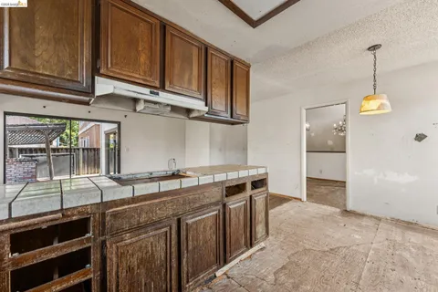 a kitchen with stainless steel appliances granite countertop a sink and cabinets