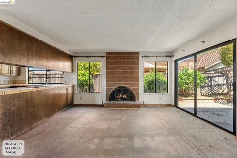 a view of a livingroom with an empty space and a fireplace