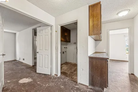 a view of a hallway with wooden shelves