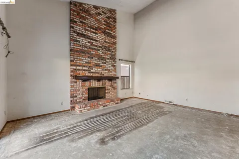 a view of an empty room with a fireplace