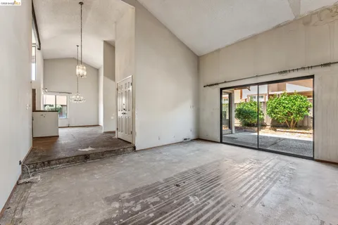 a view of a kitchen with large windows
