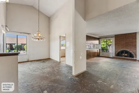 a view of a livingroom with a fireplace and window