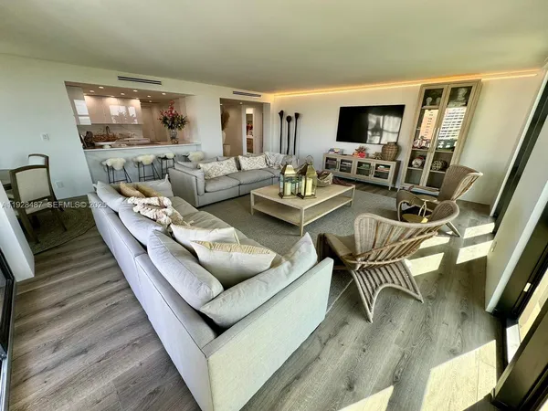 a living room with furniture flat screen tv and couches