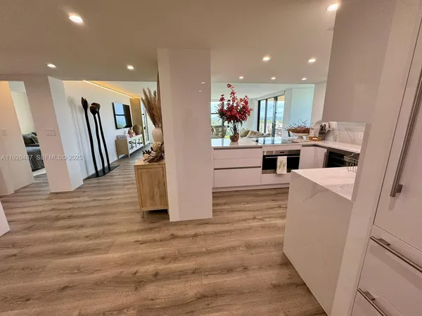 a view of living room with furniture and wooden floor