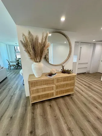 a bathroom with a sink mirror and vanity