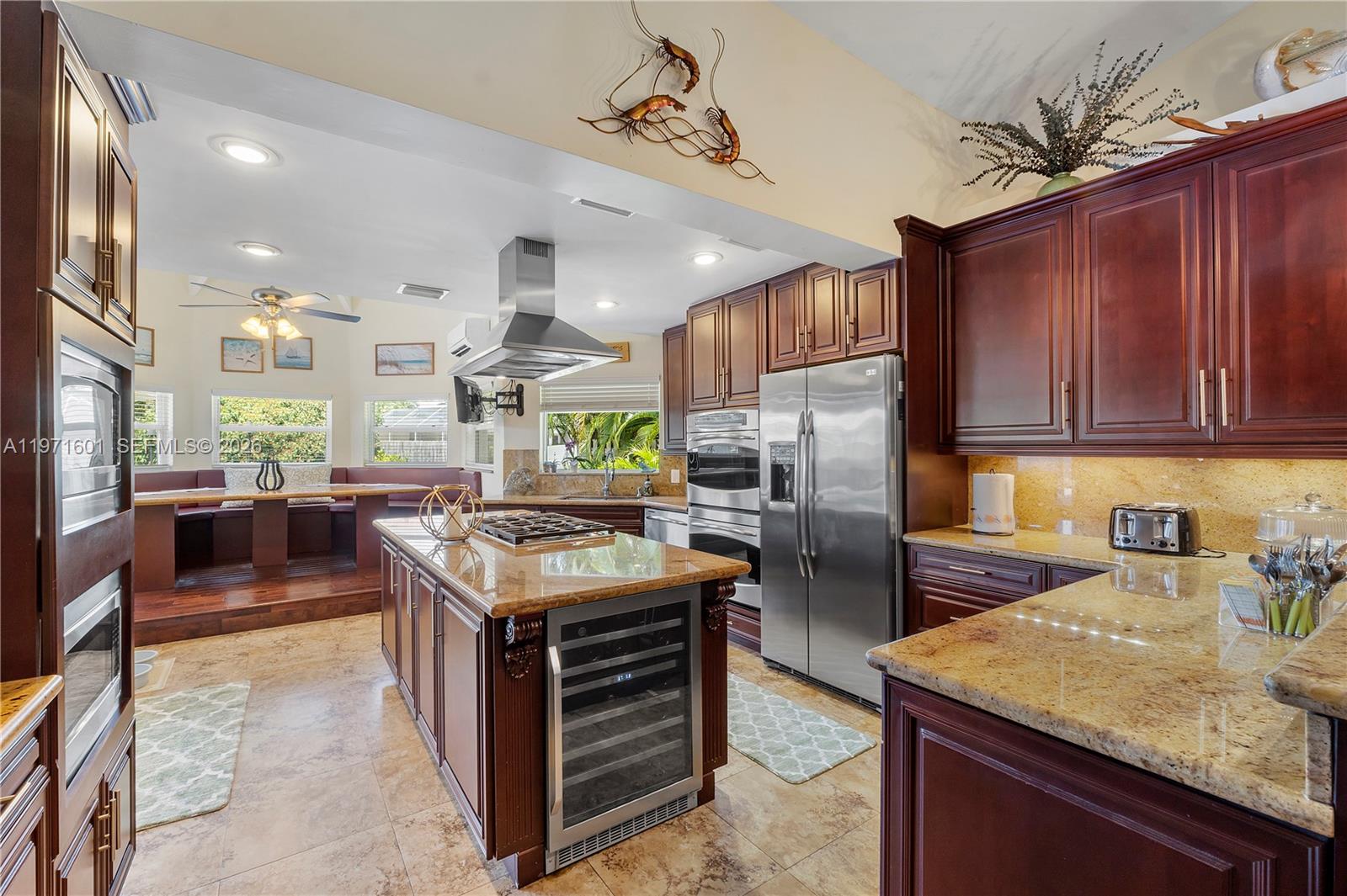 17640 Old Cutler Road Palmetto Bay, FL 33157 - Photo 13 of 56 a kitchen with stainless steel appliances granite countertop a stove top oven a refrigerator a sink and dishwasher with wooden floor