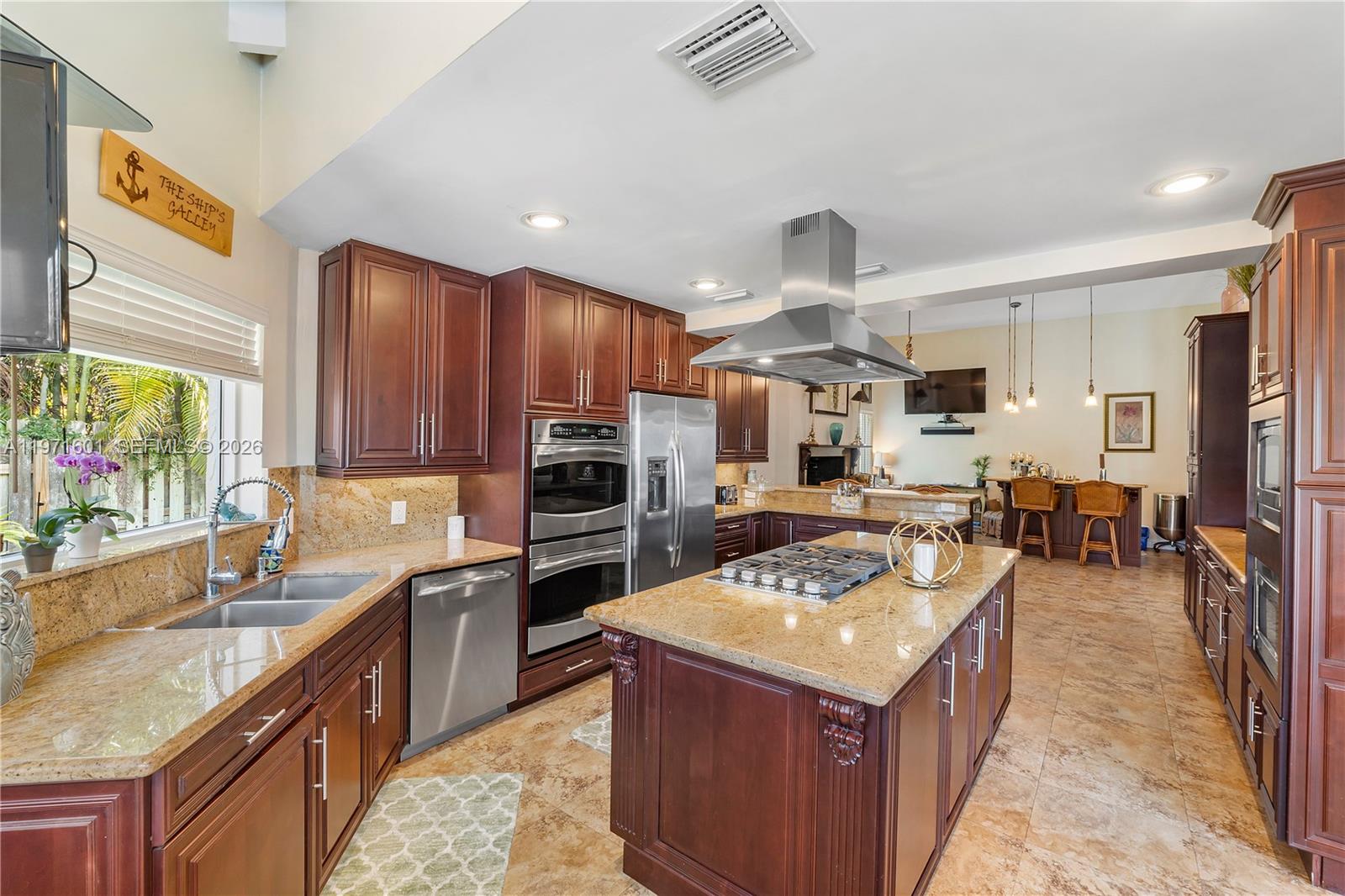 17640 Old Cutler Road Palmetto Bay, FL 33157 - Photo 16 of 56 a kitchen with a stove sink and a microwave