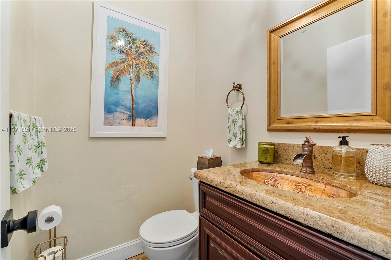 17640 Old Cutler Road Palmetto Bay, FL 33157 - Photo 18 of 56 a bathroom with a granite countertop toilet sink and mirror