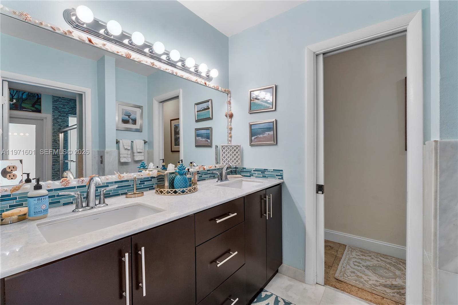 17640 Old Cutler Road Palmetto Bay, FL 33157 - Photo 21 of 56 a bathroom with a double vanity sink and a mirror