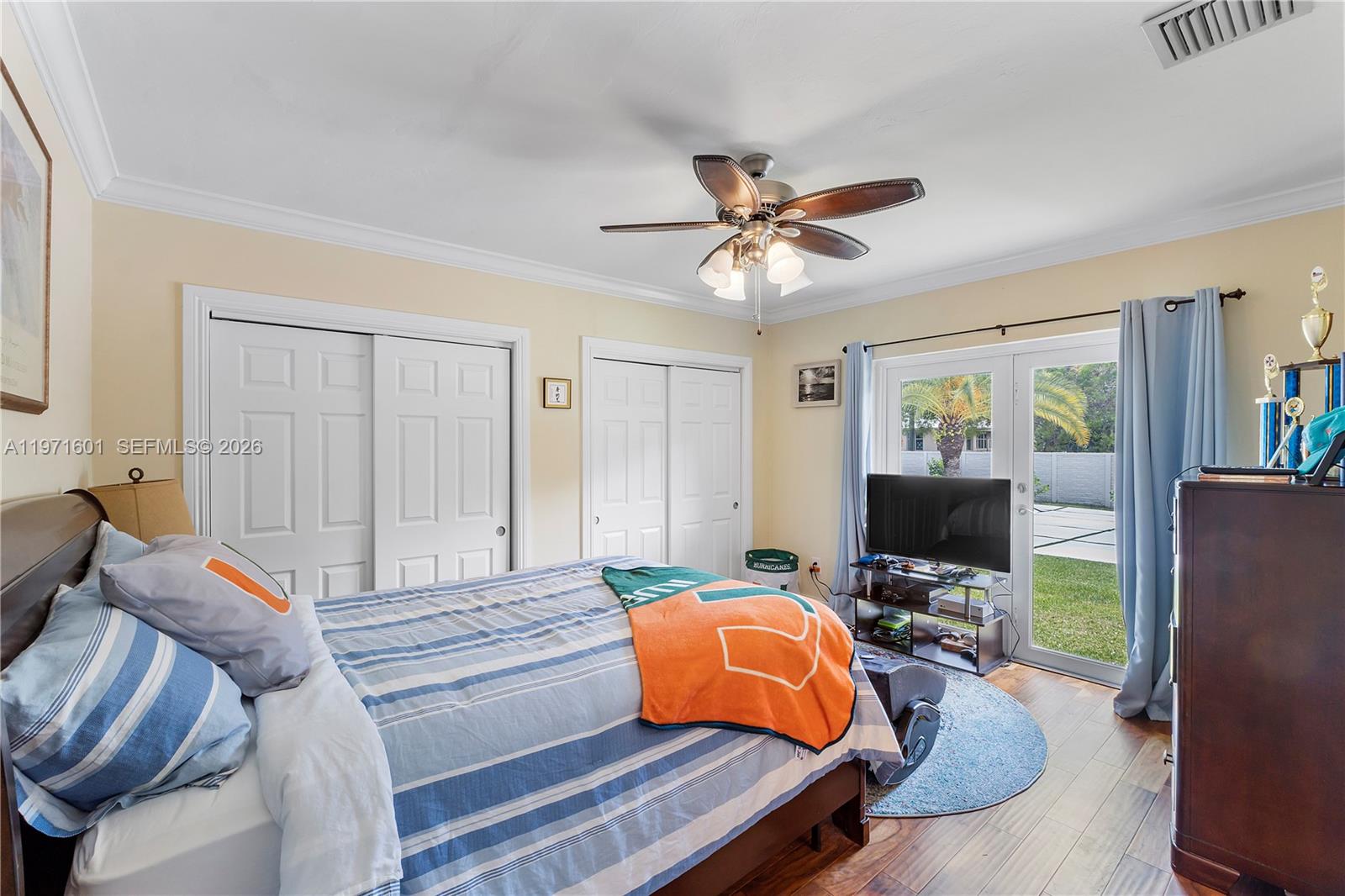 17640 Old Cutler Road Palmetto Bay, FL 33157 - Photo 24 of 56 a bedroom with a bed and a flat screen tv