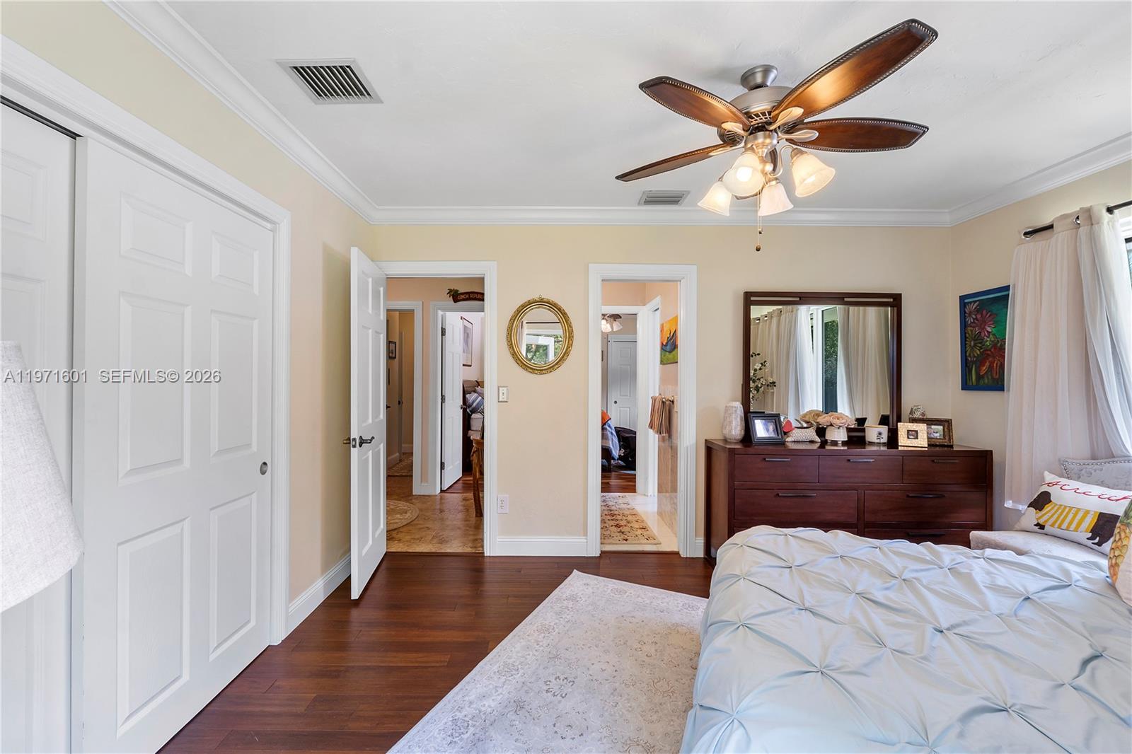 17640 Old Cutler Road Palmetto Bay, FL 33157 - Photo 26 of 56 a large bedroom with a bed and a chandelier