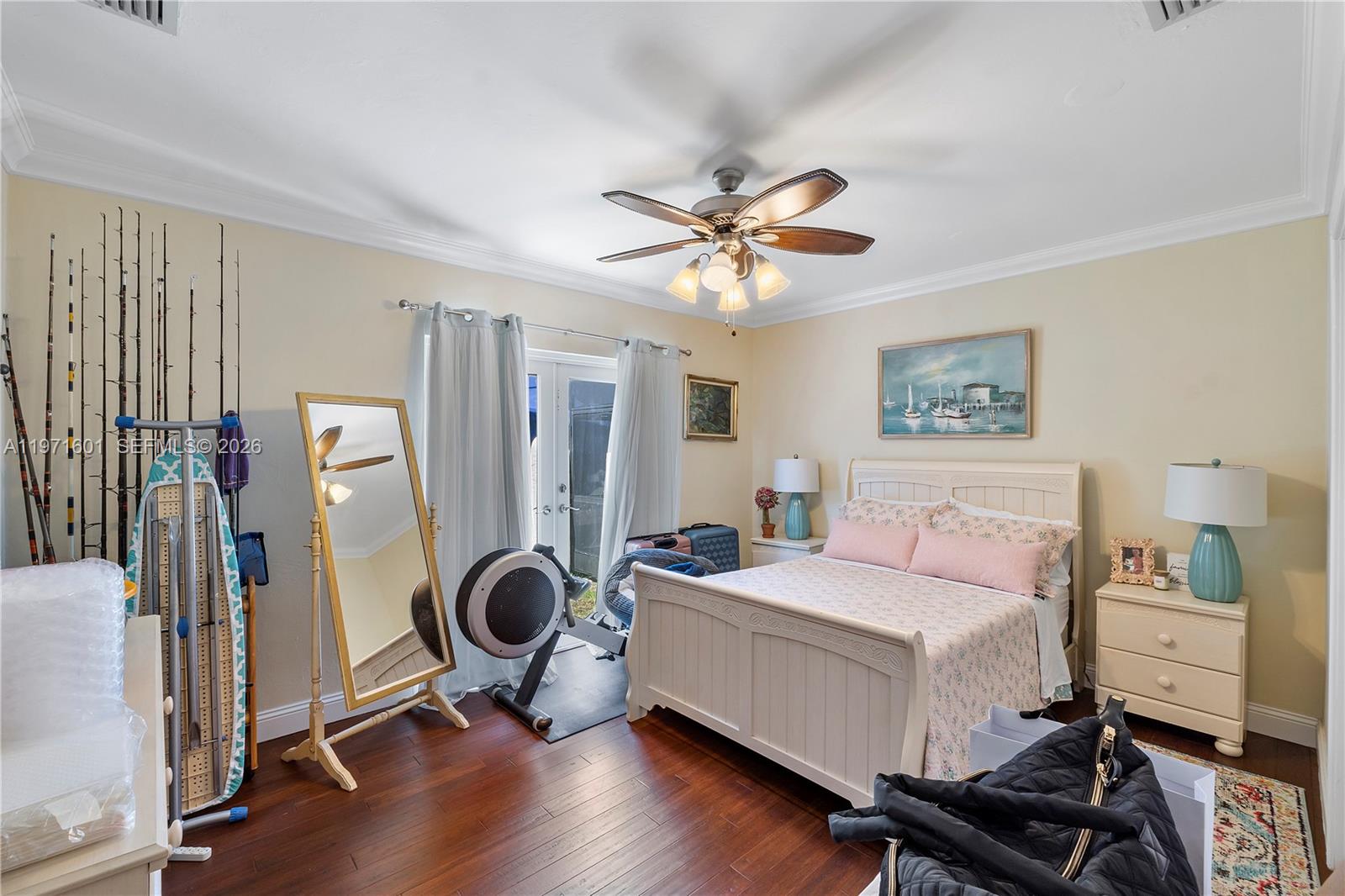 17640 Old Cutler Road Palmetto Bay, FL 33157 - Photo 28 of 56 a bedroom with furniture and a chandelier