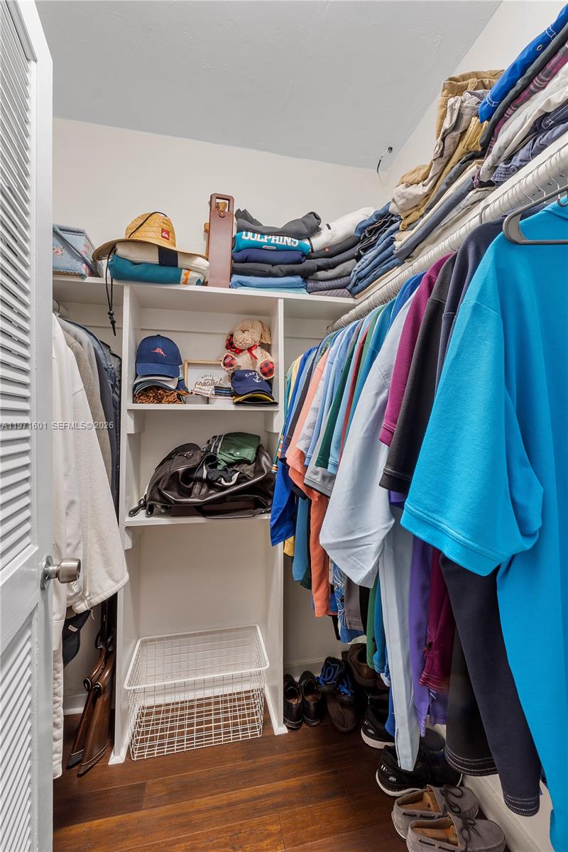 17640 Old Cutler Road Palmetto Bay, FL 33157 - Photo 37 of 56 a view of walk in closet with clothes and shoes