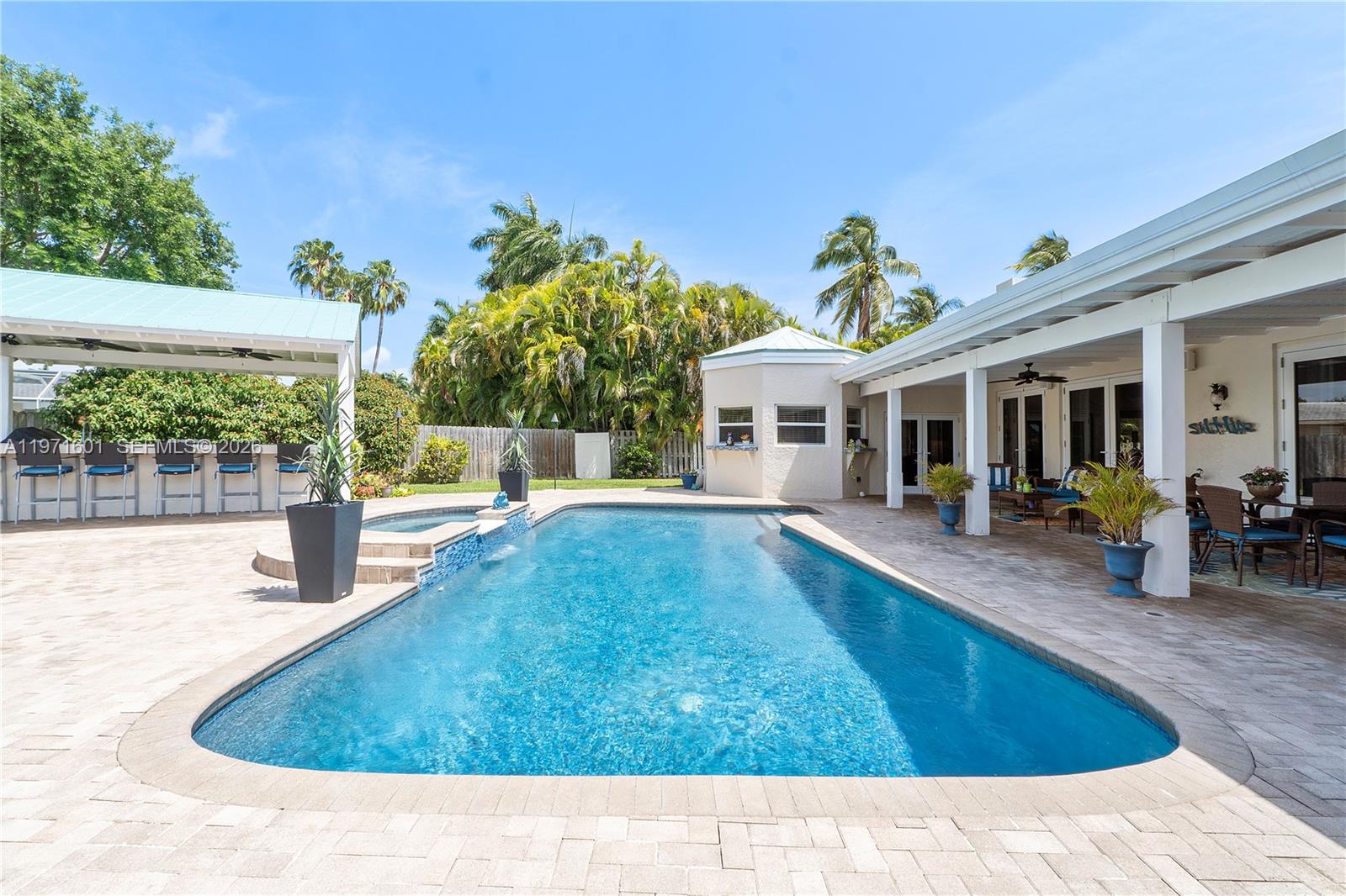 17640 Old Cutler Road Palmetto Bay, FL 33157 - Photo 42 of 56 a swimming pool with outdoor seating and yard