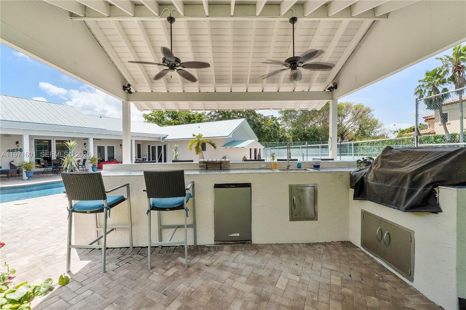 17640 Old Cutler Road Palmetto Bay, FL 33157 - Photo 43 of 56 a view of a patio with a table and chairs
