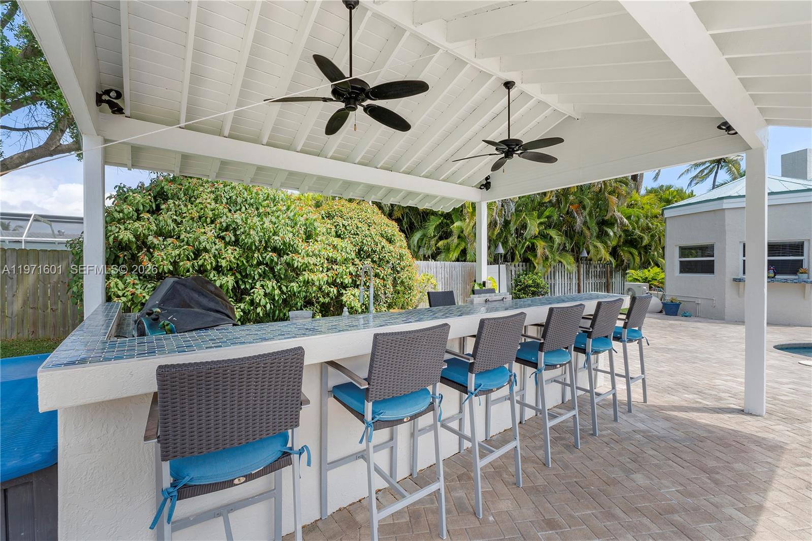 17640 Old Cutler Road Palmetto Bay, FL 33157 - Photo 44 of 56 a view of a patio with a table and chairs