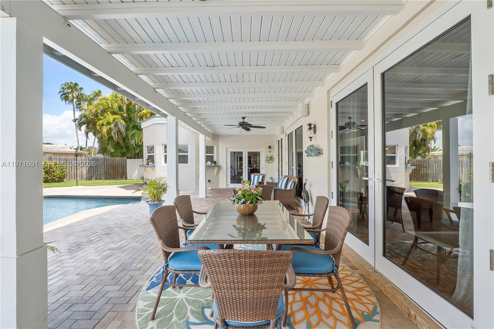 17640 Old Cutler Road Palmetto Bay, FL 33157 - Photo 45 of 56 a view of a dining room with furniture wooden floor and a chandelier