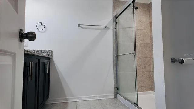 a bathroom with a shower and mirror