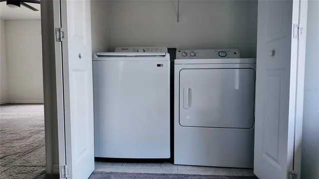 a white refrigerator freezer sitting next to a white wall