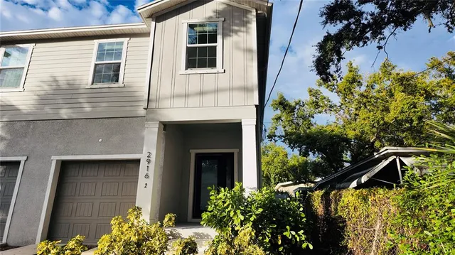 a view of a house with a flower garden