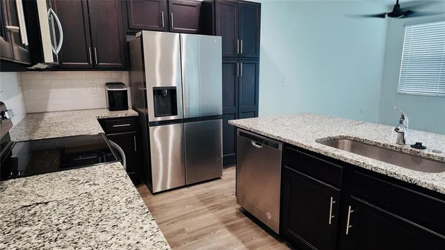 a kitchen with a refrigerator and a sink